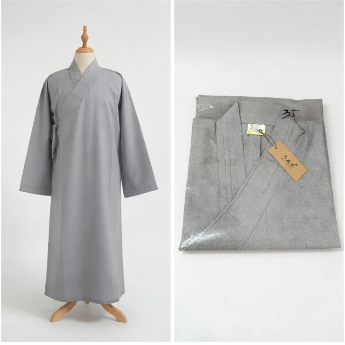 Gray traditional long robe on a dress form, with a folded matching garment and tag beside it on the right.